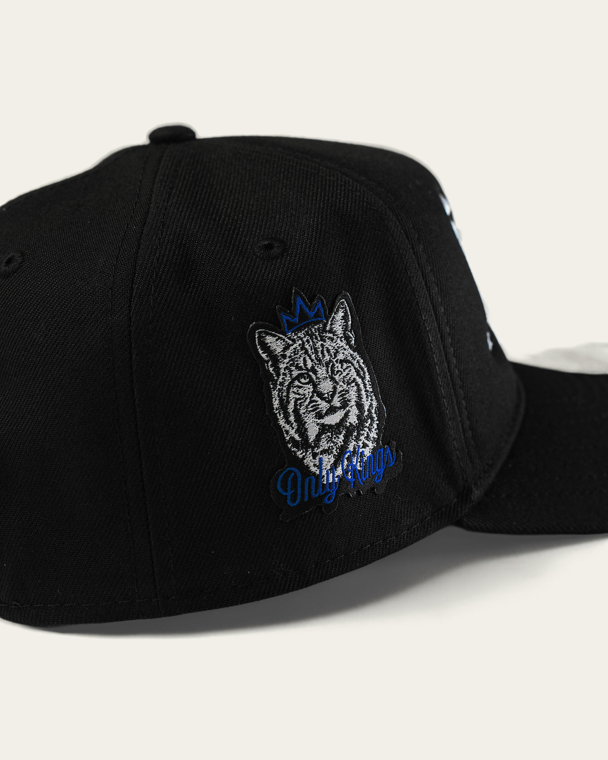 Only Kings × Cap in black, crowned Wildcat Only Kings patch on the side