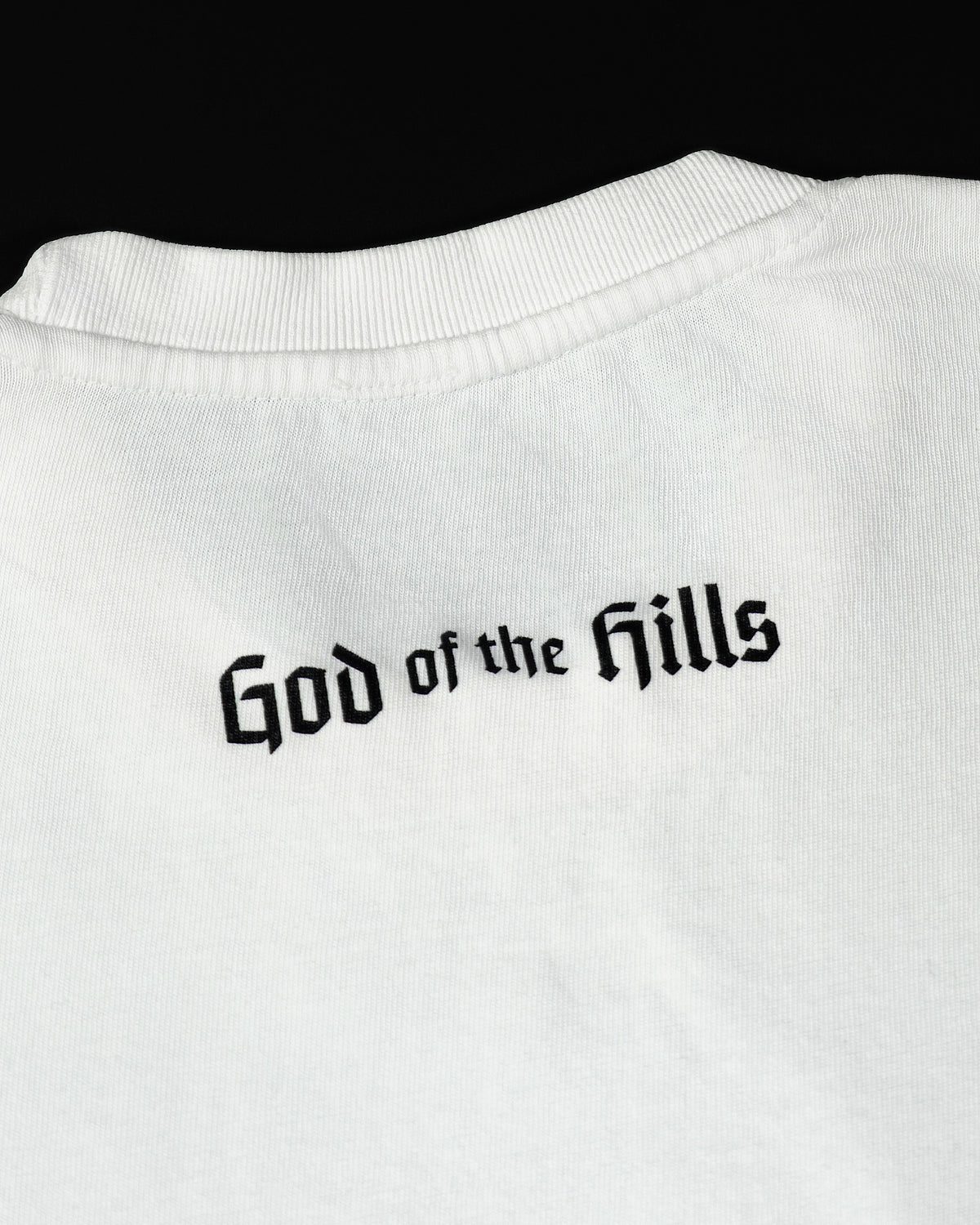 Only Kings × Wildcat Tee in pigment white, back with the God of the Hills wordmark