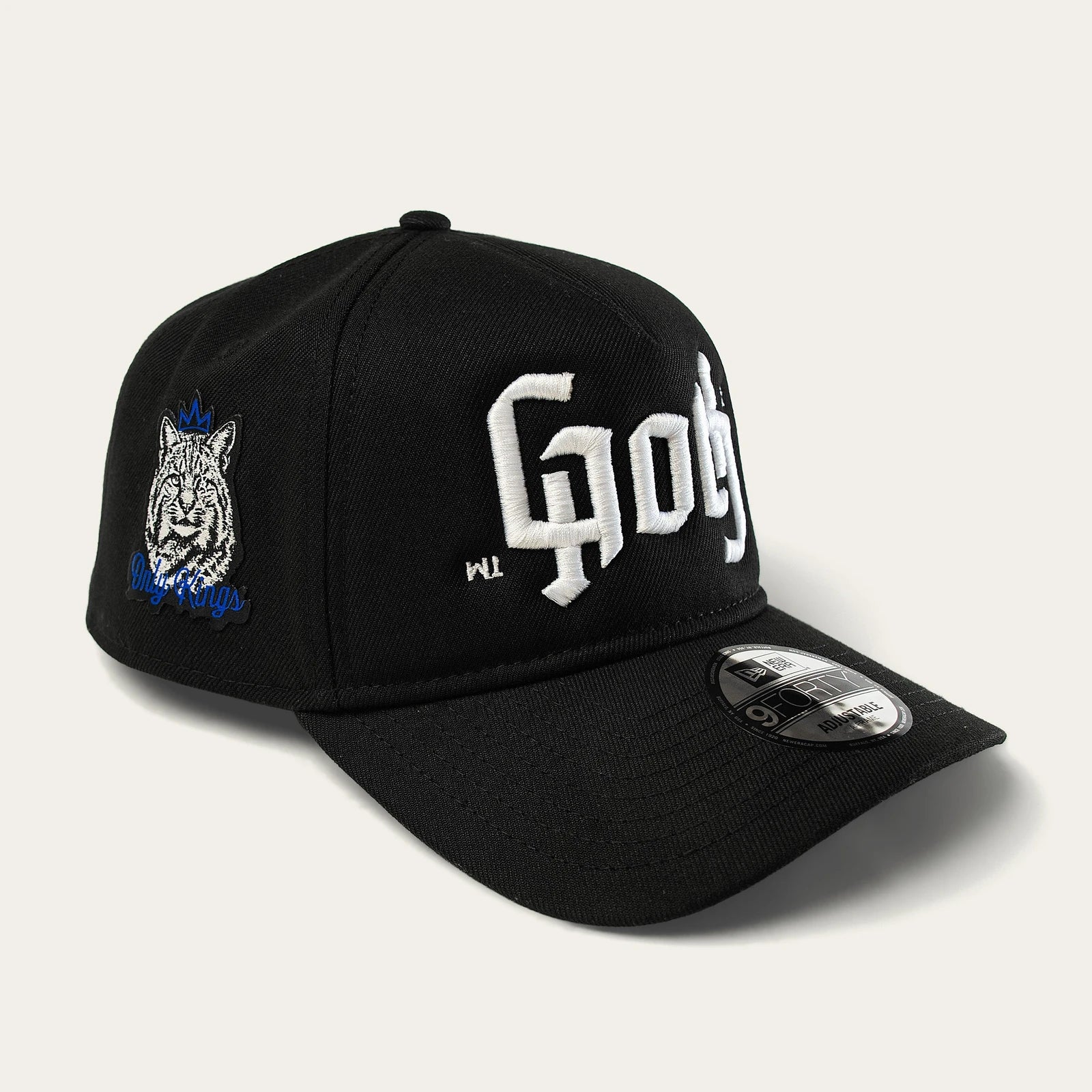 Only Kings × Cap, black, in three-quarter view showing the GOTH front embroidery and crowned Wildcat Only Kings side patch.