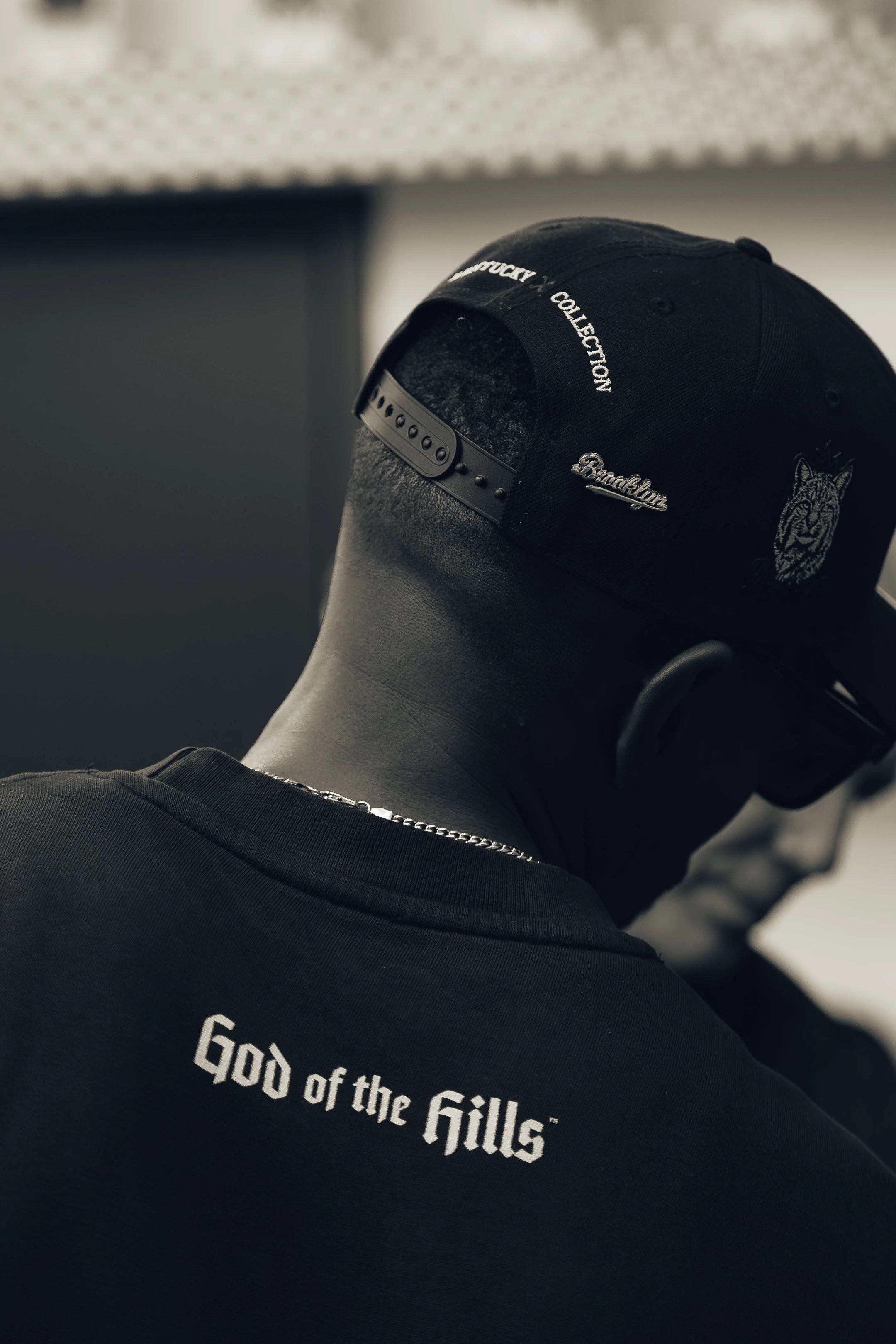 A worn GOTH cap bearing a Brooklyn pin and Kentucky Collection embroidery